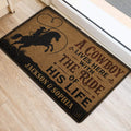 Western cowboy door mat placed at an entrance, featuring a rider on horseback and rustic typography