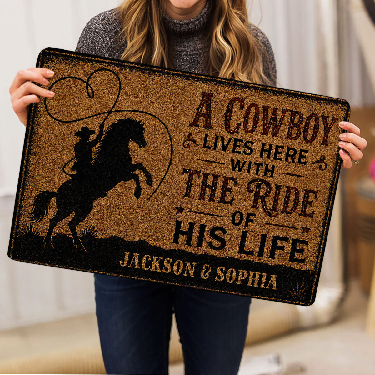 Cowboy doormat held indoors, showing a silhouetted rider on horseback and rustic Western design