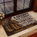 Cowboy entryway rug shown beside a glass door with rustic boots, hat and southwestern scenery