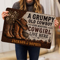 Person holding a western cowboy doormat featuring boots, hat, flowers, desert scenery and rustic lettering