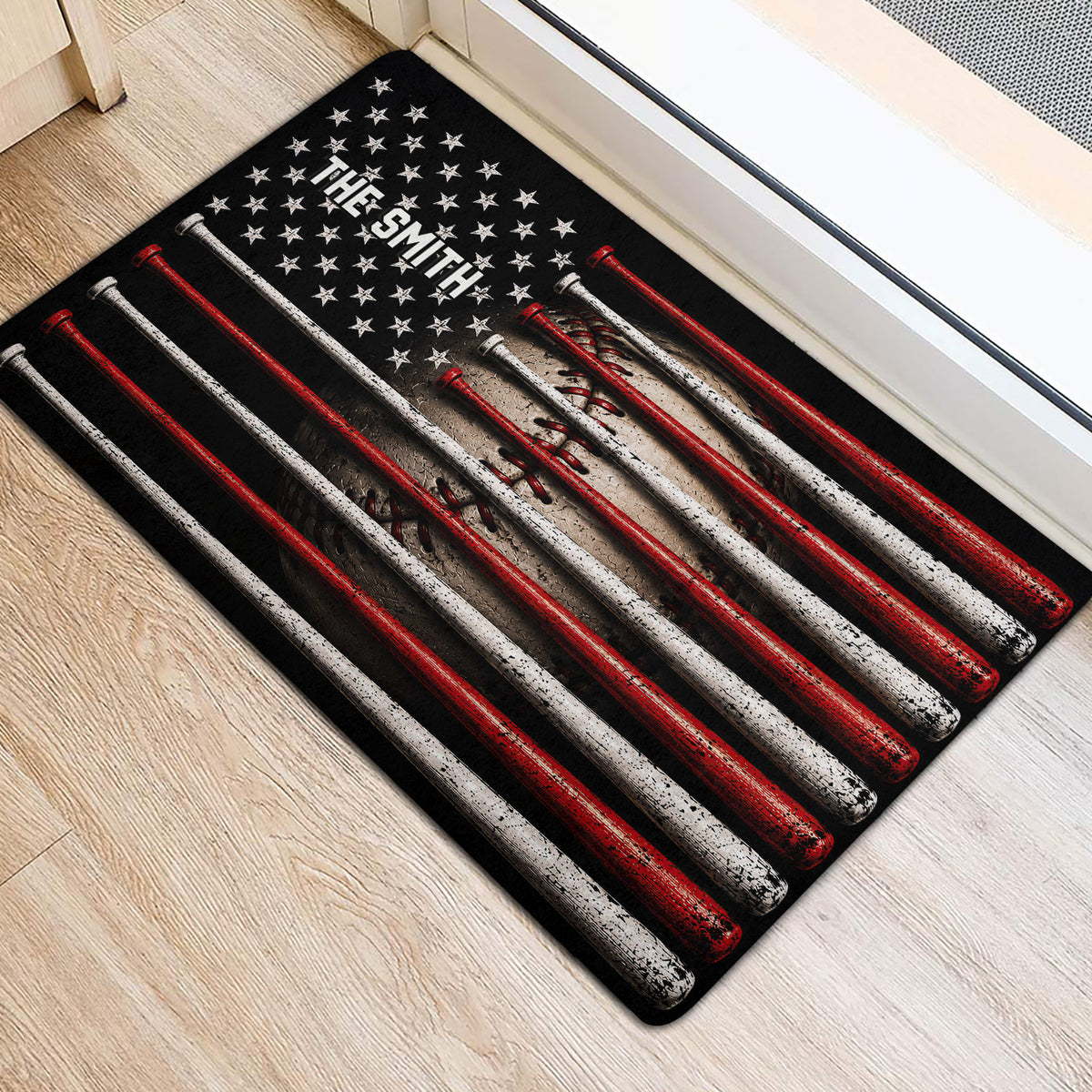 Red, white, and black baseball doormat positioned beside an indoor doorway