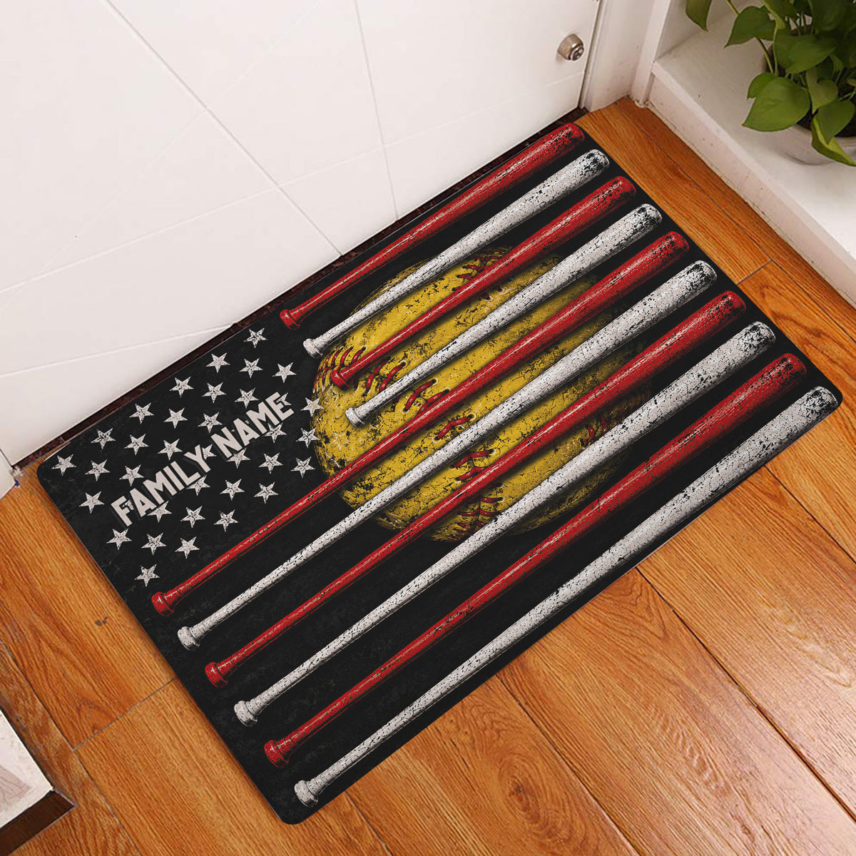 Softball entryway doormat displayed by a door on wood flooring with bats, glove, and star artwork