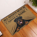 Rottweiler entryway doormat displayed by a white door on a warm wood floor
