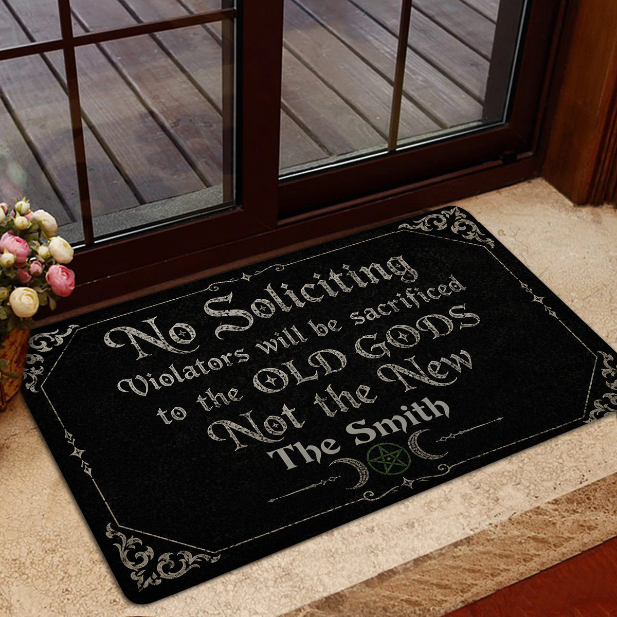 Dark Wicca entryway mat displayed by glass doors with gothic lettering and decorative occult artwork