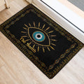 Black and gold evil eye door mat styled at an indoor entrance with geometric border details