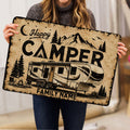 Camping-themed doormat held indoors, showing an RV, mountains, trees and campfire scene
