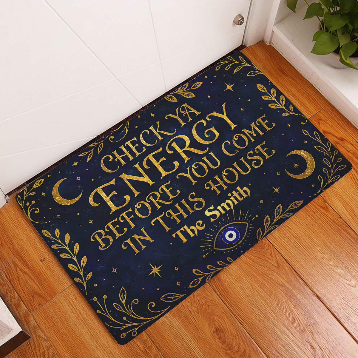 Evil eye doormat styled at an indoor doorway with gold lettering, crescent moons and leafy artwork
