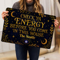 Evil eye doormat held indoors, displaying navy and gold celestial artwork with an eye symbol and moons