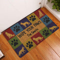 German Shepherd paw print doormat displayed by an indoor door on a wood floor