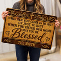 Woman holding an ornate Christian doormat featuring a cross, hearts, and a welcoming message