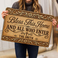 Person holding an ornate Christian blessing doormat with floral scrollwork and a cross
