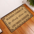 Christian blessing doormat styled at an indoor entryway beside a white door and warm wood flooring