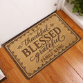 Christian entryway doormat displayed by a white door on wood flooring with ornate borders and faith-inspired wording