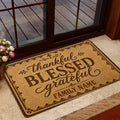 Faith-inspired Christian doormat styled near a glass door with warm brown artwork and an ornate decorative border