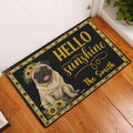 Sunflower pug doormat displayed at a front door on a warm wood entryway floor