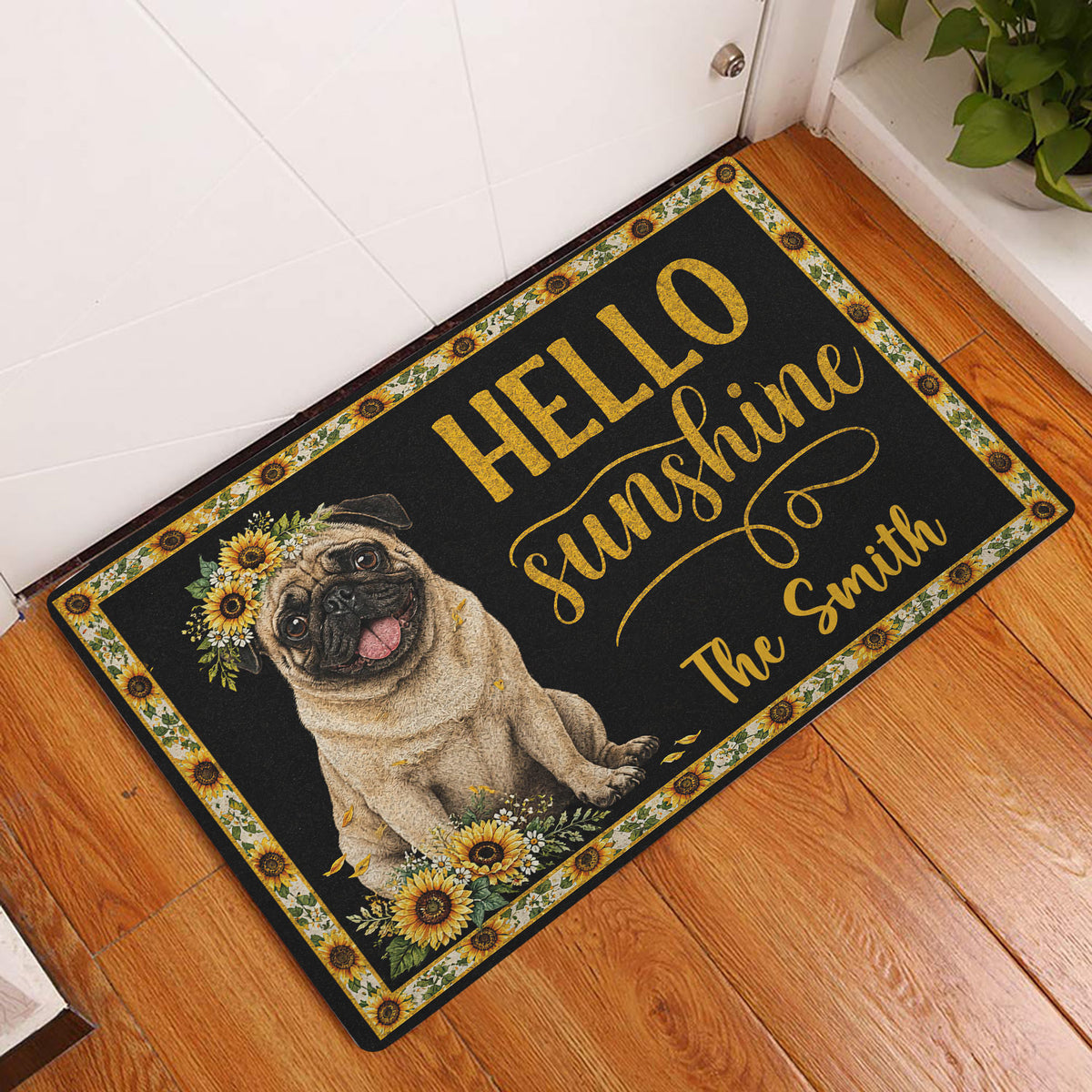 Sunflower pug doormat displayed at a front door on a warm wood entryway floor