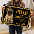 Person holding a sunflower-framed pug doormat with cheerful golden entryway artwork