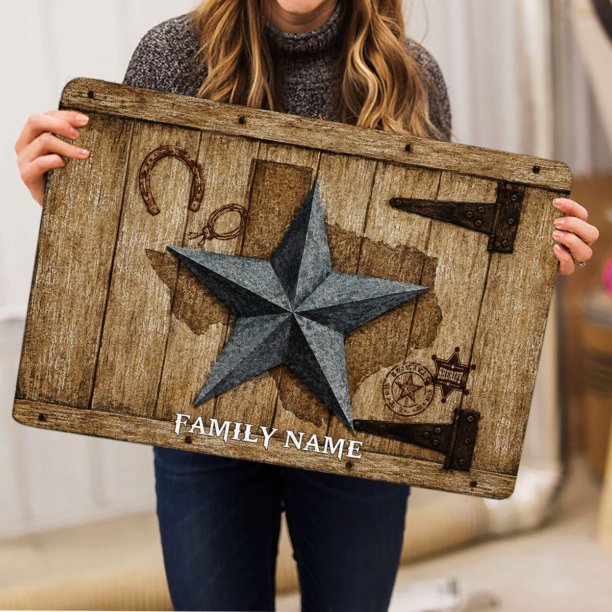 Person holding a rustic Texas western doormat featuring a star, horseshoe, lasso, and sheriff badge