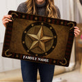 Person holding a rustic Texas western doormat featuring a central star and horseshoe design