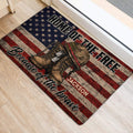 Veteran-themed American flag door mat positioned beside a doorway on a light wood floor