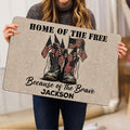 Person holding a patriotic veteran doormat featuring military boots and American flags