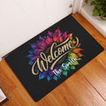 Colorful sunflower welcome doormat styled at a home entryway on a warm wood floor
