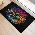 Vibrant sunflower entryway mat displayed beside a doorway on light wood flooring