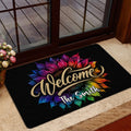 Rainbow sunflower welcome doormat placed inside a glass entrance door on a beige floor