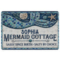 Mermaid doormat with blue and teal tail artwork, seashells, starfish, and a playful coastal welcome message