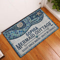 Mermaid entryway rug displayed beside a white door on hardwood flooring with blue ocean-inspired artwork