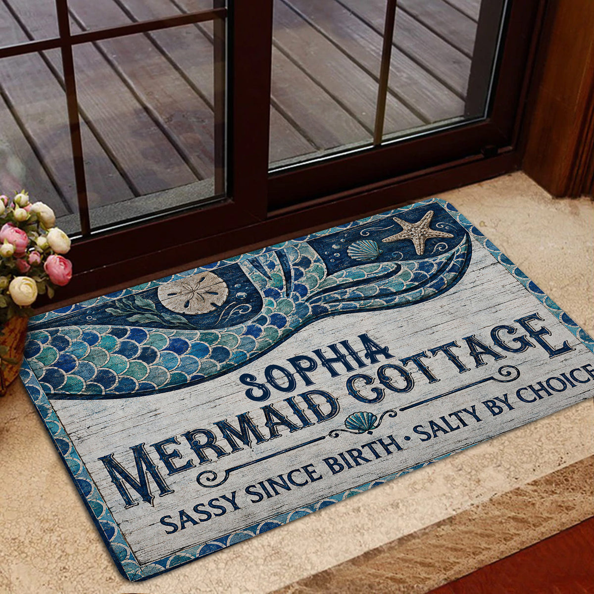 Mermaid doormat styled at a home entrance with ocean artwork, a decorative border, and coastal colors