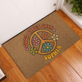 Colorful hippie peace sign flower doormat displayed at a home entryway