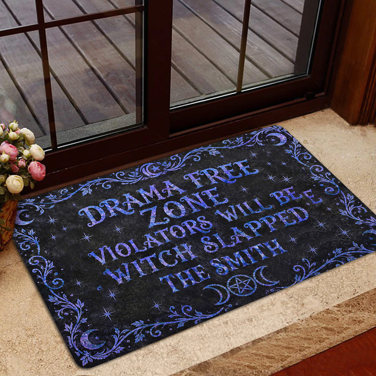 Wicca entryway rug displayed by a glass door with moon phase, star, and botanical design