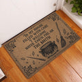 Wicca doormat styled in an indoor entryway beside a white door and wood flooring