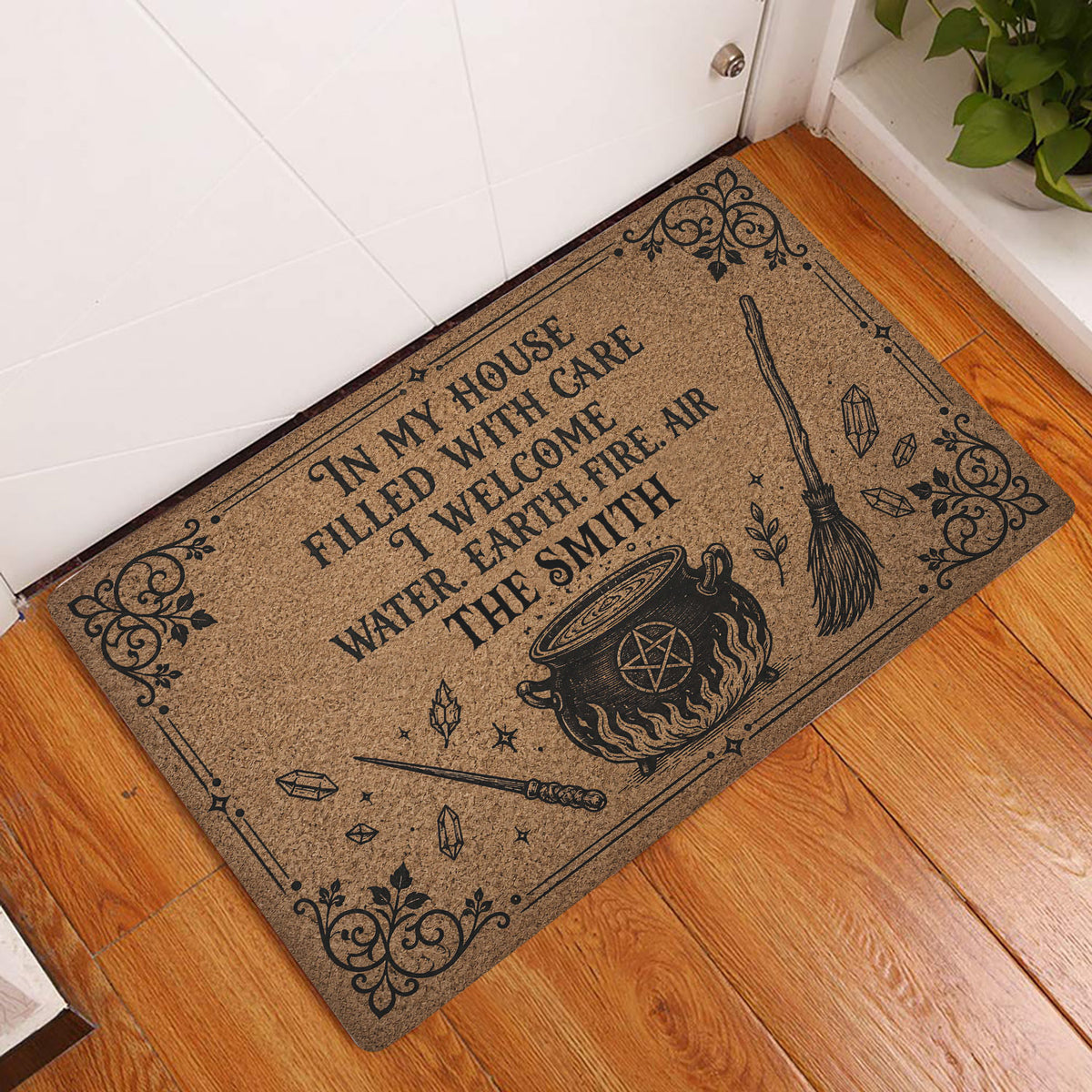 Wicca doormat styled in an indoor entryway beside a white door and wood flooring