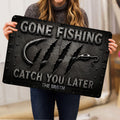 Person holding a fishing doormat featuring a large hook, dramatic claw marks, and bold lettering