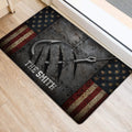 Angler-inspired fishing doormat positioned near an entryway, featuring hooks, stars, and vintage flag stripes