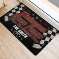 Race fan door mat positioned near a doorway, featuring black and red artwork with checkered racing flags