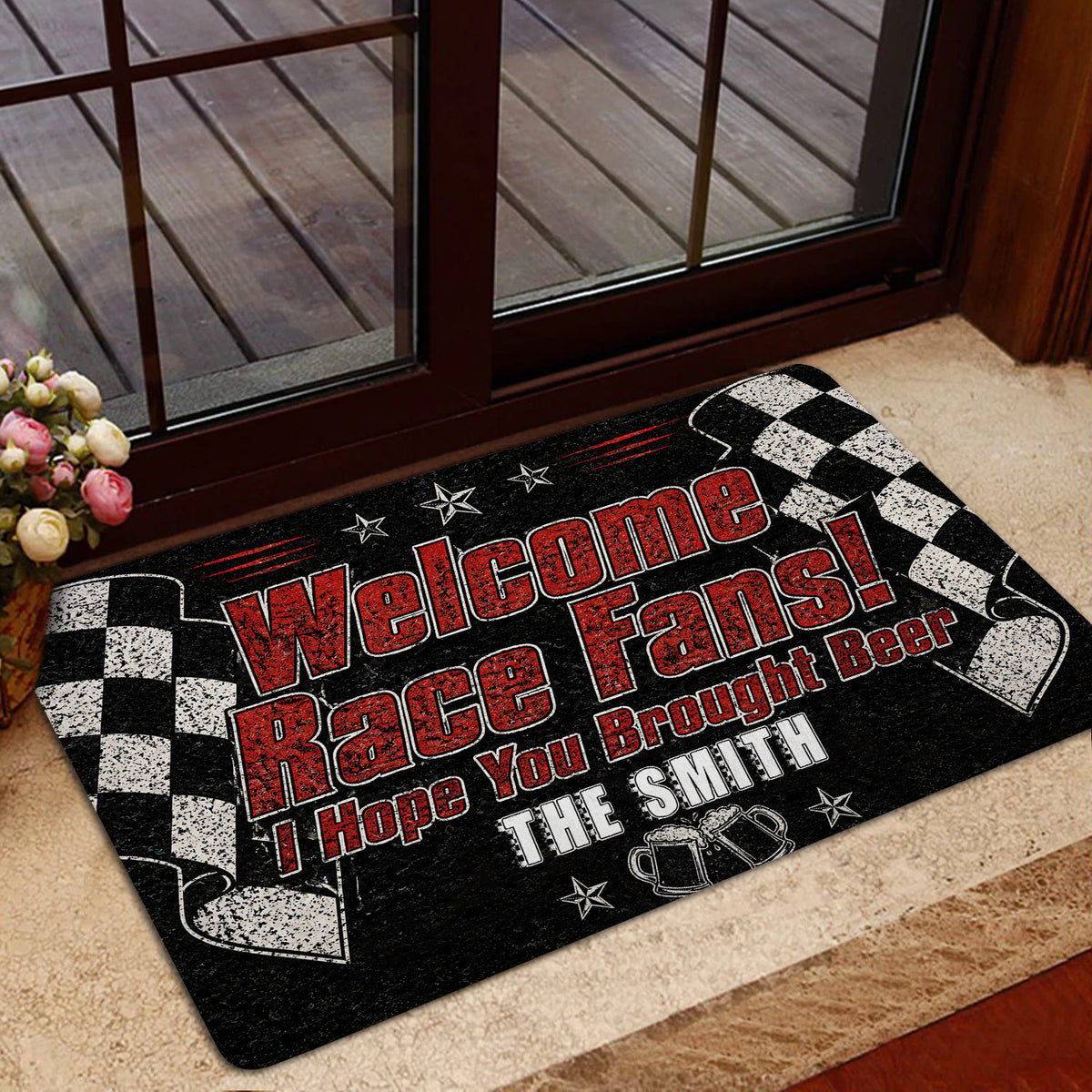 Racing doormat styled beside a glass door with checkered flags, beer mugs, and bold red and white lettering