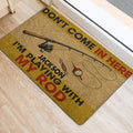 Fishing rod and tackle doormat positioned beside a doorway on light wood flooring