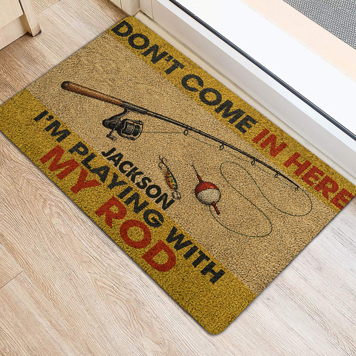 Fishing rod and tackle doormat positioned beside a doorway on light wood flooring