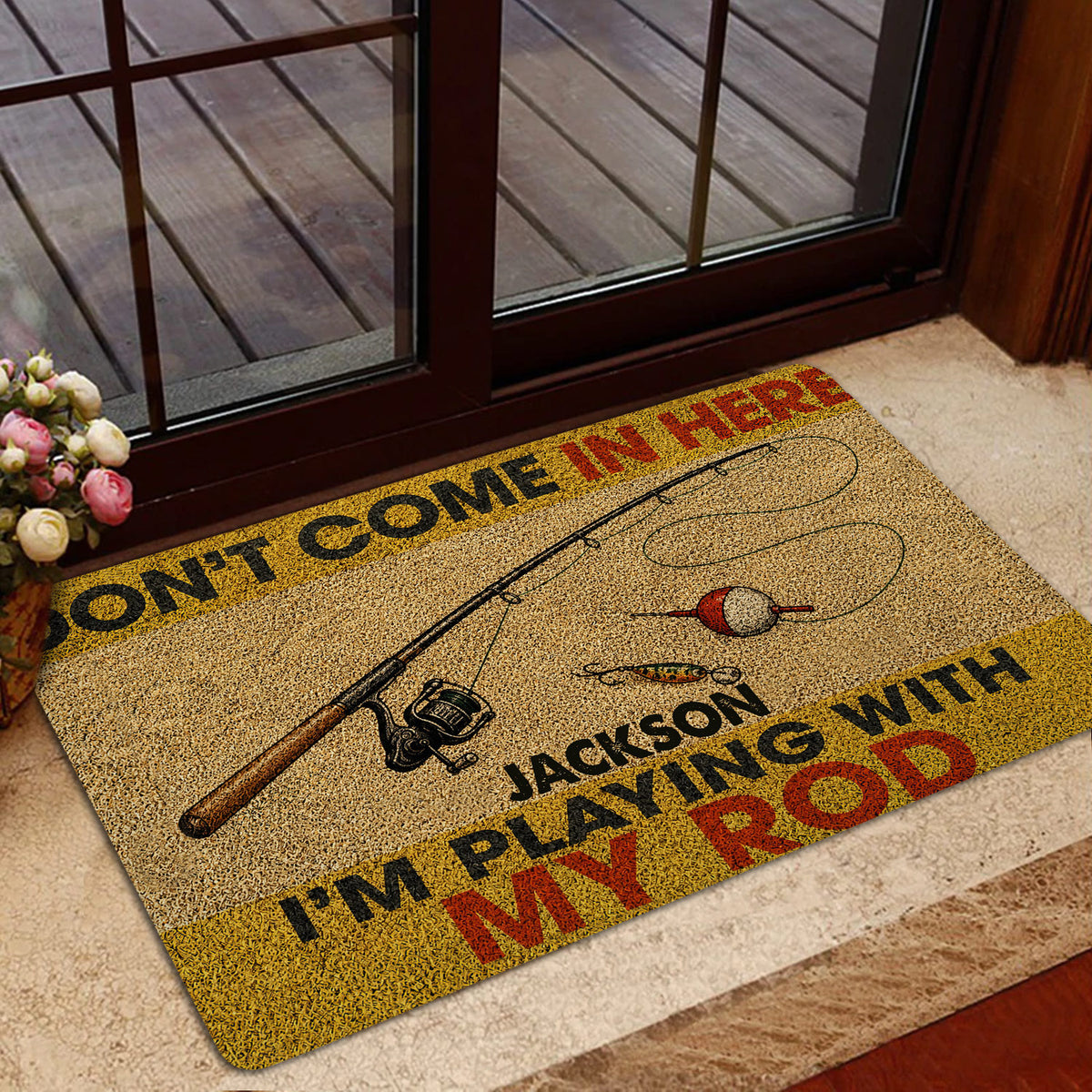 Fishing doormat displayed near a glass door with a wood deck visible outside