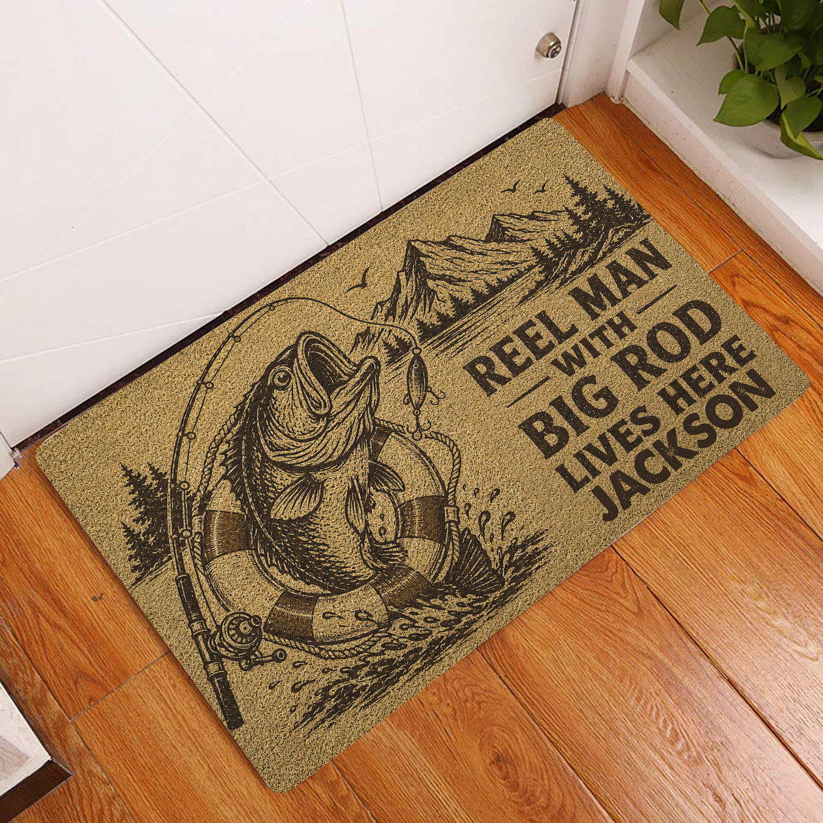 Fishing doormat displayed at a home entrance with a fish, rod, mountains, and rustic artwork
