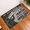 Hunting doormat displayed by a front door on hardwood flooring with rustic graphic artwork