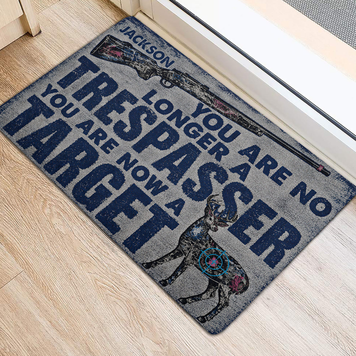 Hunting-themed front door mat with rifle, deer artwork, and bold typography in a home entryway