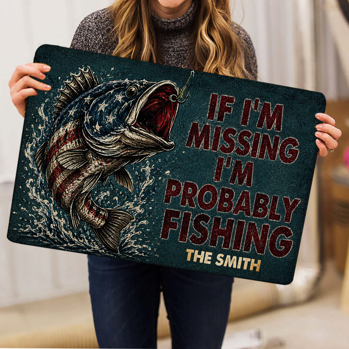 Fishing-themed doormat held indoors, showing the detailed fish illustration and distressed typography