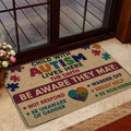 Autism awareness doormat styled at a home entrance with colorful puzzle artwork and supportive wording