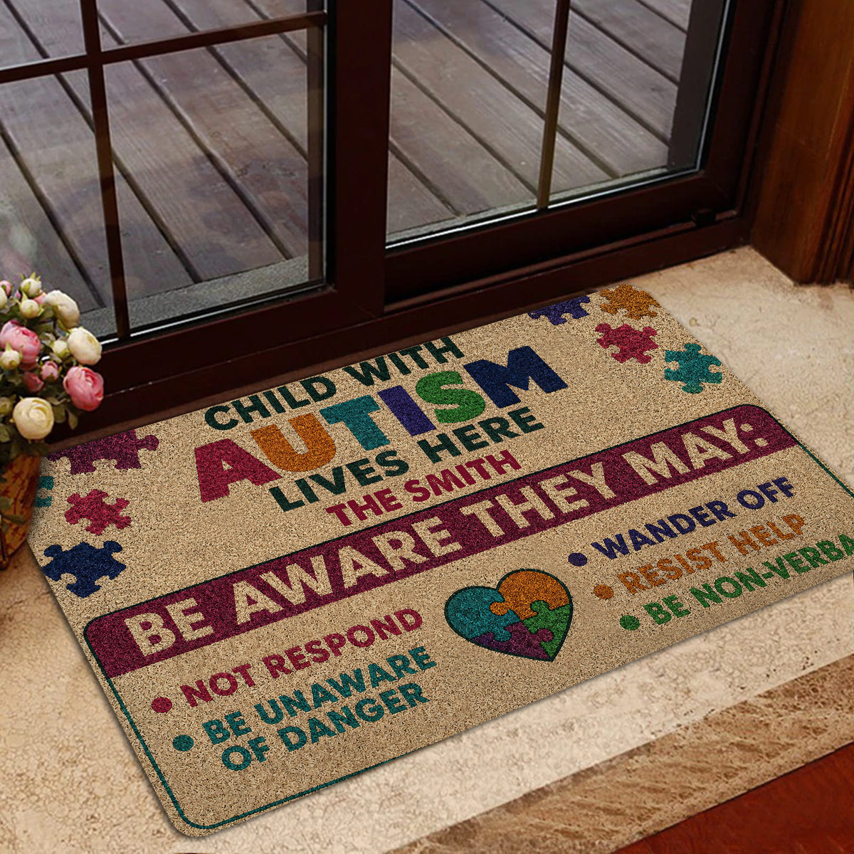 Autism awareness doormat styled at a home entrance with colorful puzzle artwork and supportive wording