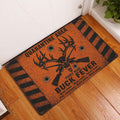 Orange and black buck hunting doormat displayed on a wood floor beside an entry door