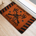 Hunting-themed deer skull doormat positioned at an indoor doorway on light wood flooring